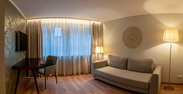 Suite | Double Bed with Living Room & View to Cathedral — room at Hotel zum Rappen Freiburg, Freiburg — photo 4 of 8